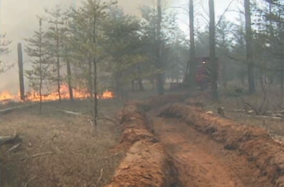 dirt trench with fire in the background